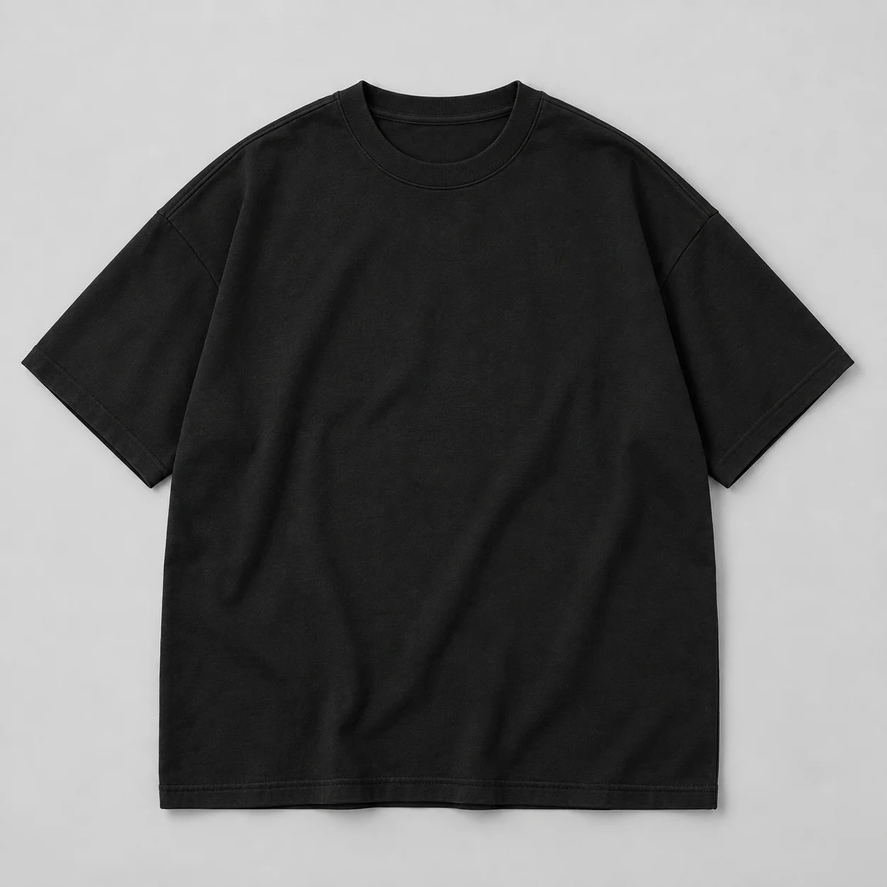 Illustrative black oversized drop-shoulder cotton tshirt, front view